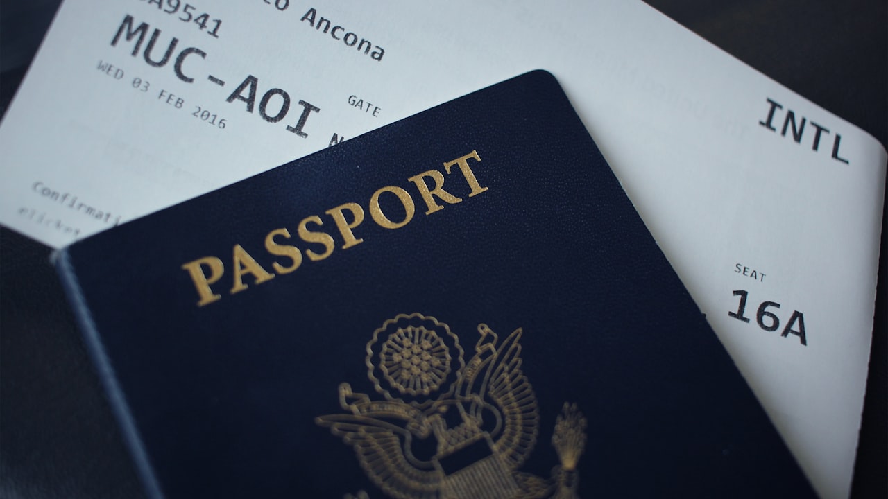 passport booklet on top of white paper