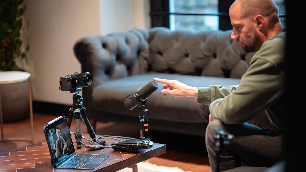 Man points at microphone during podcast recording