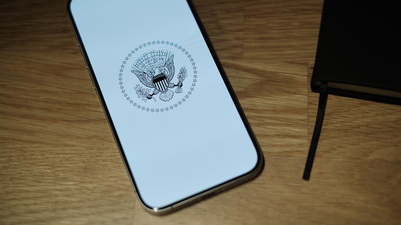 A white iPhone sitting on top of a wooden table