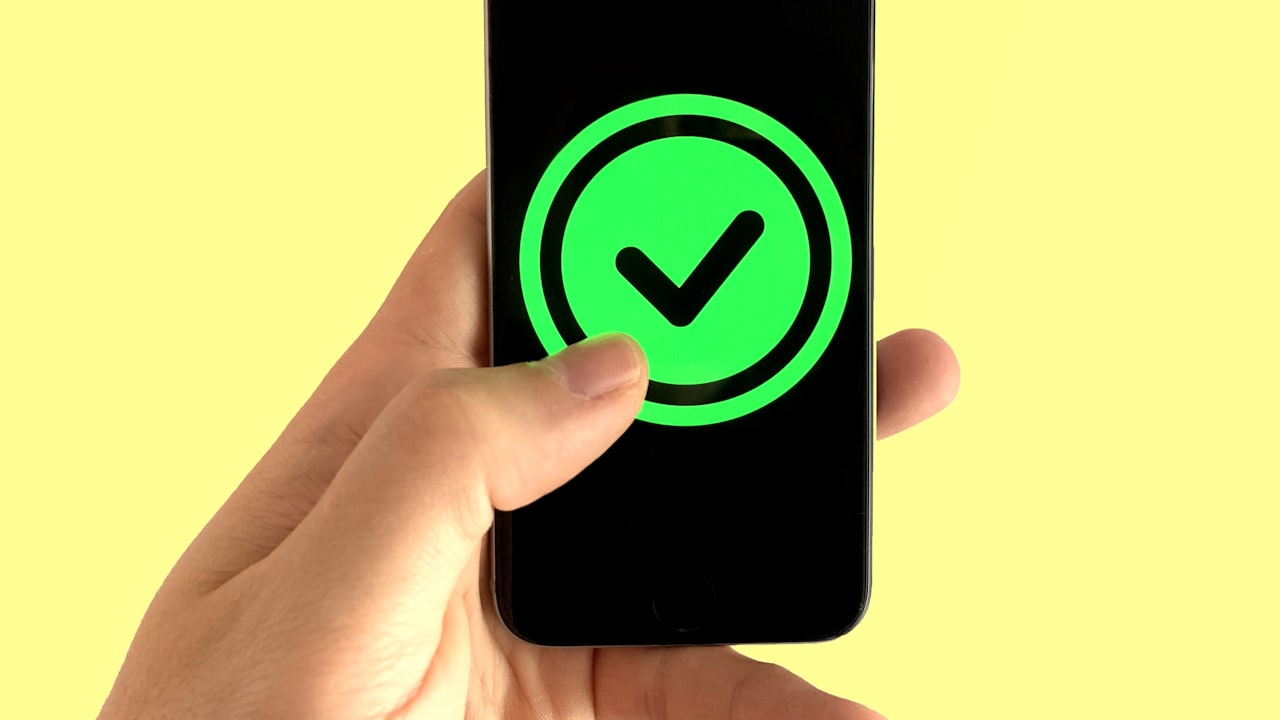 black android smartphone displaying green and black logo