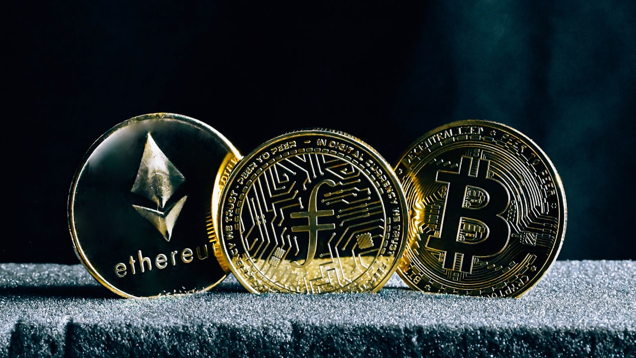 three bitcoins sitting on top of a table